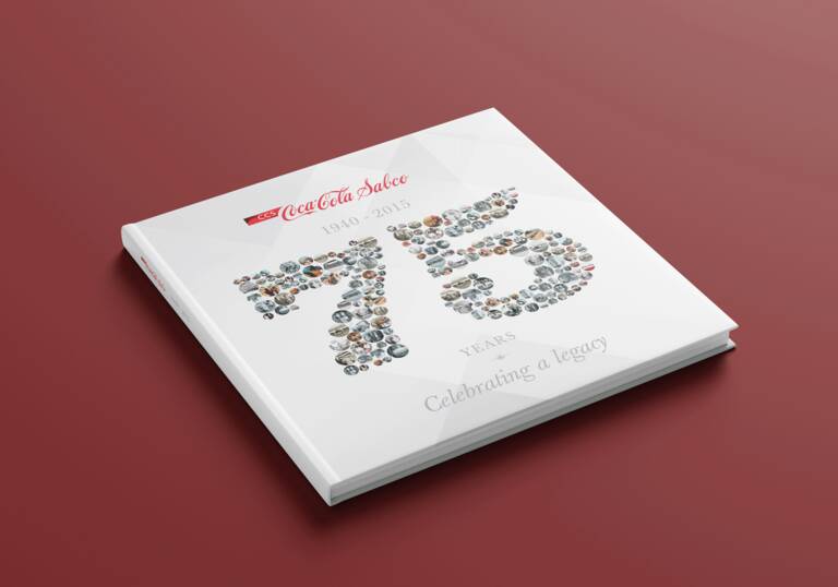 SIMONSAYS DIGITAL AGENCY Coca-Cola commemorative book featuring "75 Years" displayed with images celebrating its legacy.