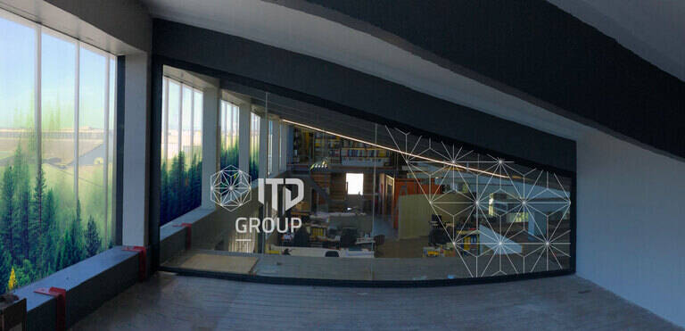 SIMONSAYS DIGITAL AGENCY ITP Group office interior featuring large windows with forest graphics and a modern workspace.