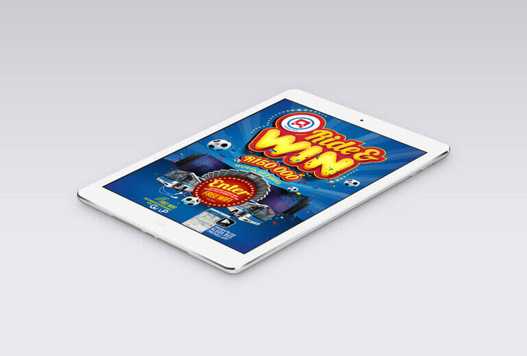 SIMONSAYS DIGITAL AGENCY Promotional tablet display featuring a "Ride & Win" contest with bright graphics and prizes.