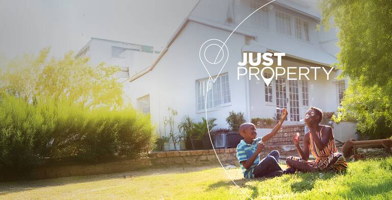 SimonSAYS Creative Agency branding for Just Property, featuring a joyful family moment in front of a home to promote lifestyle-focused real estate marketing